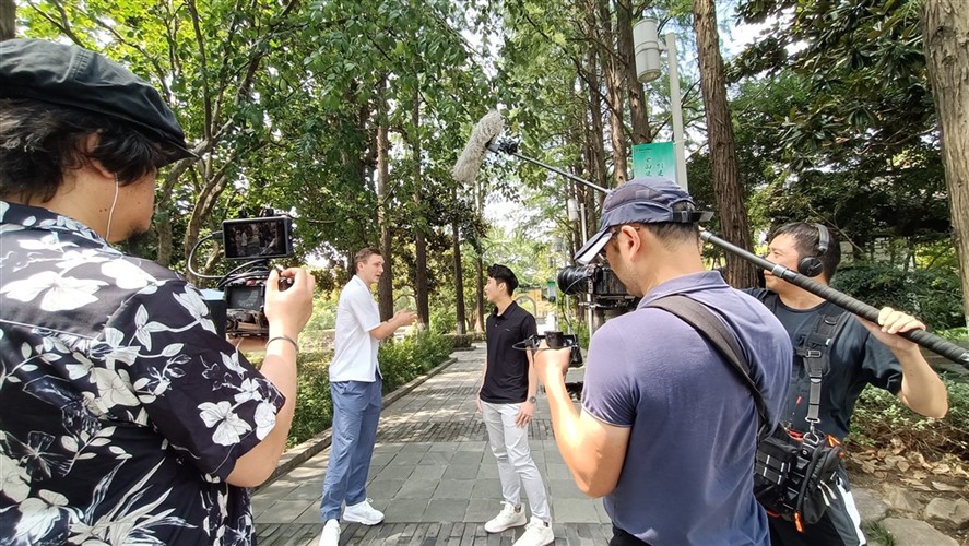 Crew filming an on-location interview in China.